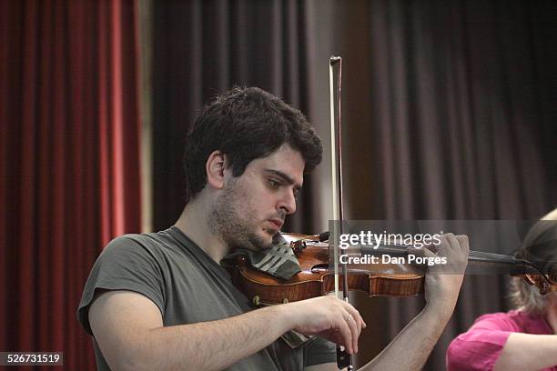 Violinist Michael Barenboim, son of pianists Daniel Barenboim and Elena Bashkirova, plays the violin, in rehearsal on the stage of the Mary Nathaniel...