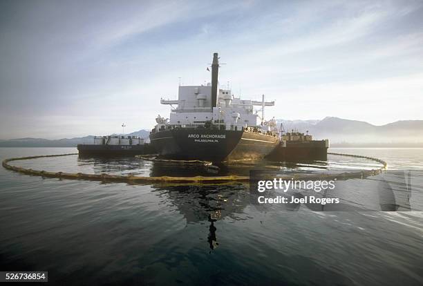 Containment boom attempts to hold oil from a leaking ARCO tanker in the Straits of Juan de Fuca, off Port Angeles. Washington, USA. | Location: near...