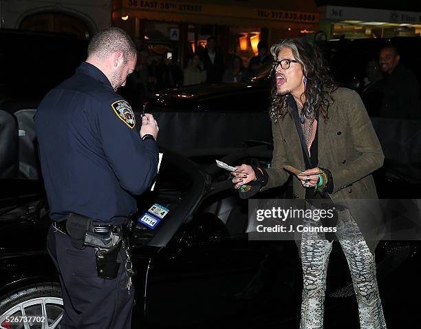 Musician Steven Tyler haggles over a parking ticket prior to the "Steven Tyler...Out On A Limb" Kick Off Celebration at Lavo on April 30, 2016 in New...