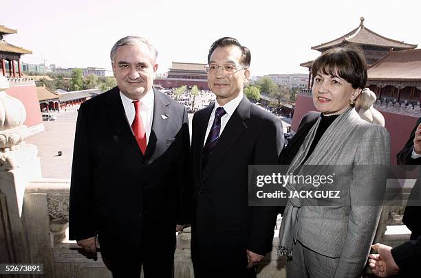French Prime Minister Jean-Pierre Raffarin and his wife Anne-Marie pose with Chinese Prime Minister Wen Jiabao during a visit to the inauguration of...