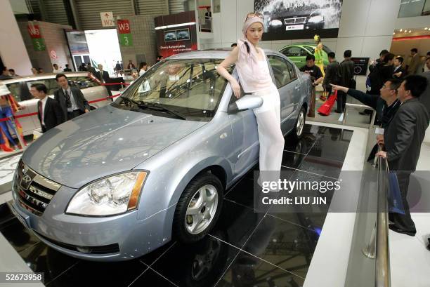 Model poses with a car by private-owned Chinese manufacturer Chery at the Auto Shanghai 2005 show, 21 April 2005. The biggest annual international...