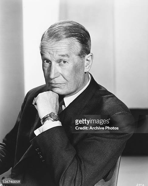 Portrait of actor Maurice Chevalier resting his chin on his hand, as he appears in the film 'Gigi', 1958.