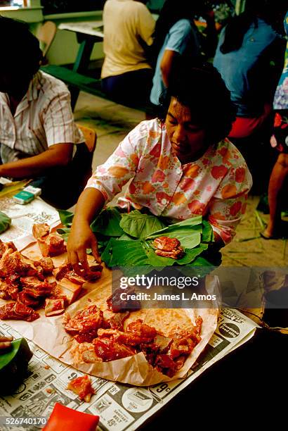 People make lau-laus, which are beef and pork wrapped in taro tops & ti leaves, for a luau to celebrate road improvements. Milolii, Hawai | Location:...