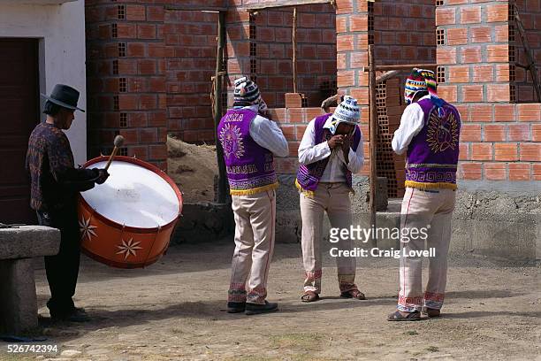 Bolivian musicians playing Zampona panpipe flutes and a Bombo drum on the Isle of the Sun in Lake Titicaca.