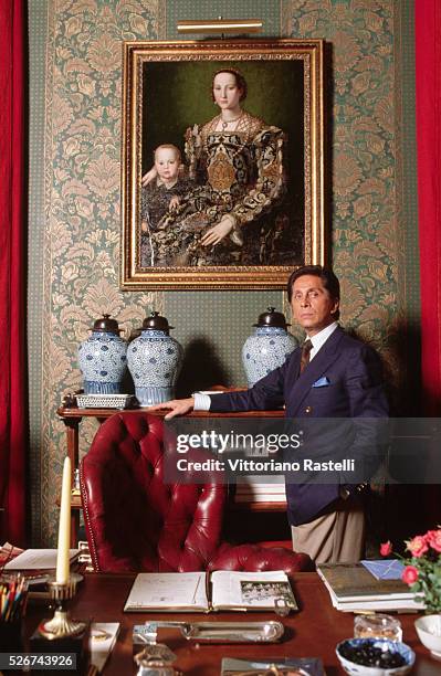 Valentino stands by a desk in his atelier in Rome, Italy.