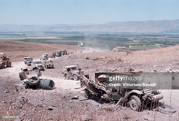 An Israeli military convoy passes destroyed vehicles during the Six-Day War. By June 10 when the fighting was halted, Israel had won territory four...