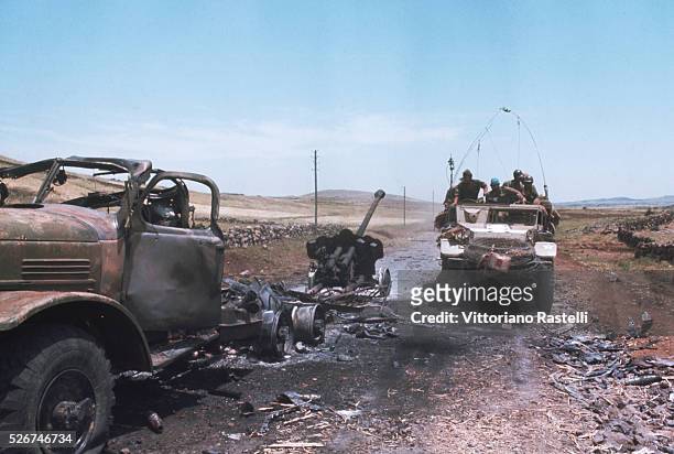 An Israeli military vehicle passes other vehicles destroyed during the Six-Day War. By June 10 when the fighting was halted, Israel had won territory...