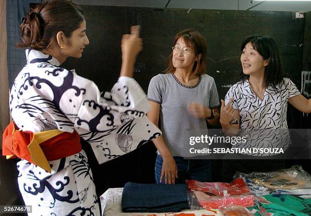 An Indian college student draped in a summer cotton Kimono 'Yukata' gestures as she speaks with Japanese lecturers during a 'Indian Japan Initiative'...