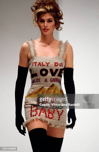 Cindy Crawford models Dolce e Gabbana clothes at a fashion show in Milan.