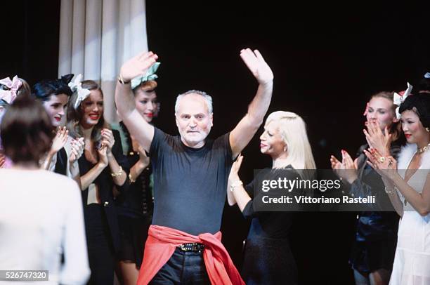 Gianni Versace is applauded at the end of a showing of his "instant collection" in Milan, Italy.