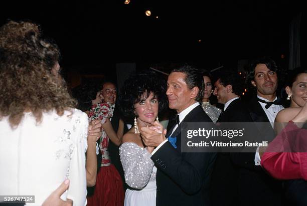 Elizabeth Taylor dances with designer Valentino at his anniversary party celebrating 30 years in the fashion business.