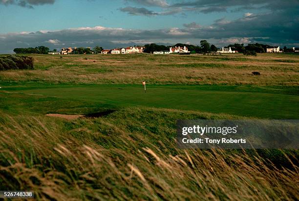 Tall grass grows in the rough along the fairway of the third hole at the Muirfield Golf Course.