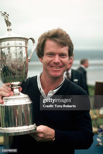 Tom Watson smiles as he holds the trophy he won at the 1982 U.S. Open Golf Tournament