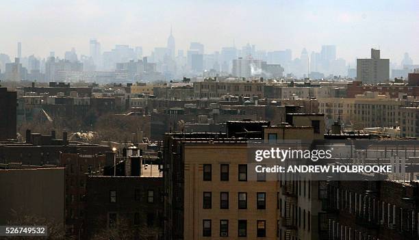 The New York City skyline is viewed through the haze from the Bronx.