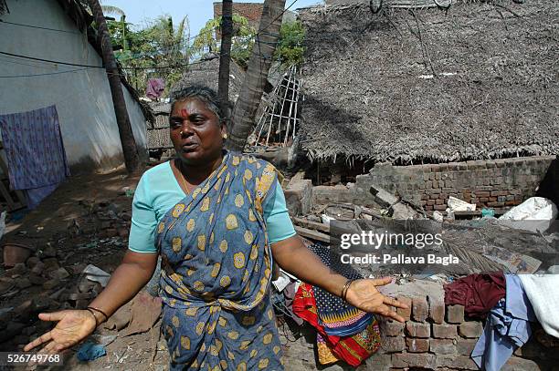 Woman stands in front of her house in the village of Vamba Keera Palayam where a meter of water destroyed about 100 houses. The United Nations...