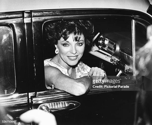 Actress Joan Collins smiling from a car window, as she arrives at a reception for ABC Television, at the Century Plaza Hotel, Hollywood, September...