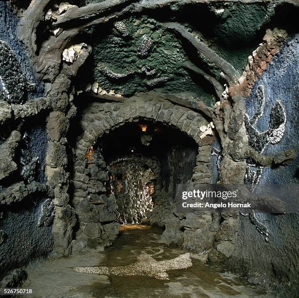 Fishes made of shells embellish the walls of a tunnel in a grotto at Leeds Castle, in Kent. The fish were designed by Simon Verity, with help from...