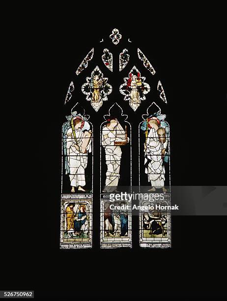 Angels flank Saint Cecilia in the central panel of a window in Christ Church Cathedral, Oxford. The window was designed by Sir Edward Burne-Jones.