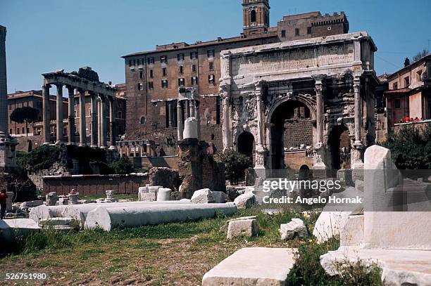 Colonnade of the Temple of Saturn lies beyond the ruined Arch of Septimus Severus, erected in 203 A.D..