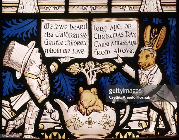 The Alice Window is a memorial to Lewis Carroll, the author of the children's book Alice in Wonderland. This pane depicts the Mad Hatter, the March...