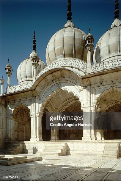 Marble arches and onion domes of the Moti Masjid or Pearl Mosque which stands within the grounds of the Red Fort, in Delhi. The mosque was built for...