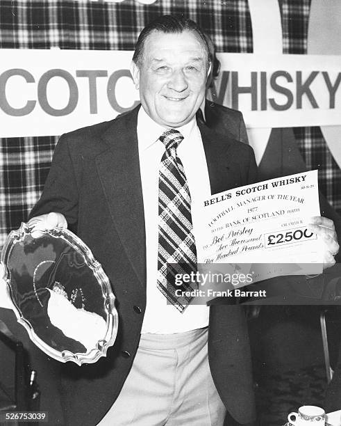 Liverpool Football Club manager Bob Paisley holding a check and silver salver, after winning Football Manager of the Year, at the Cafe Royal, London,...