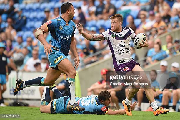 Cameron Munster of the Storm runs with the ball during the round nine NRL match between the Gold Coast Titans and the Melbourne Storm on May 1, 2016...