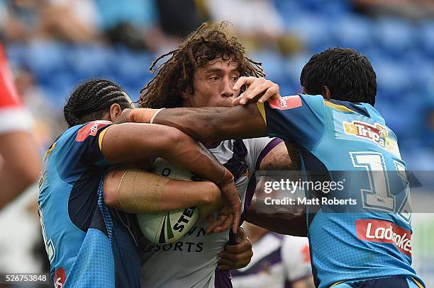 Kevin Proctor of the Storm is tackled during the round nine NRL match between the Gold Coast Titans and the Melbourne Storm on May 1, 2016 in Gold...