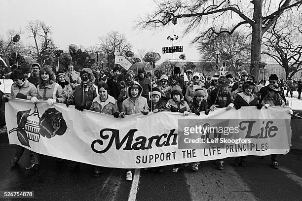Group of anti abortionists hold a "March for Life" banner during a rally on the Supreme Court anniversary of Roe vs. Wade in Washington DC.