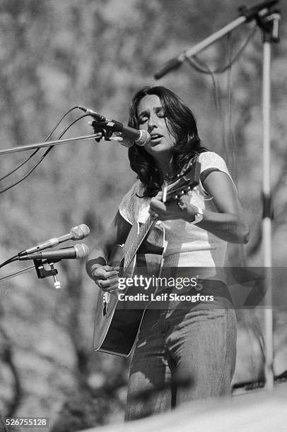 Joan Baez sings and plays the guitar while she performs in Central Park for a group of anti-war activists who celebrate the end of the Vietnam War....