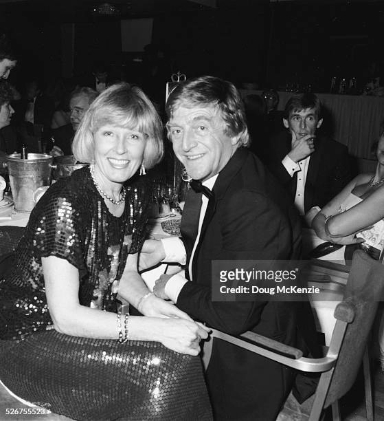Broadcaster Michael Parkinson and his wife Mary, seated at a dinner table at an event, 1984.