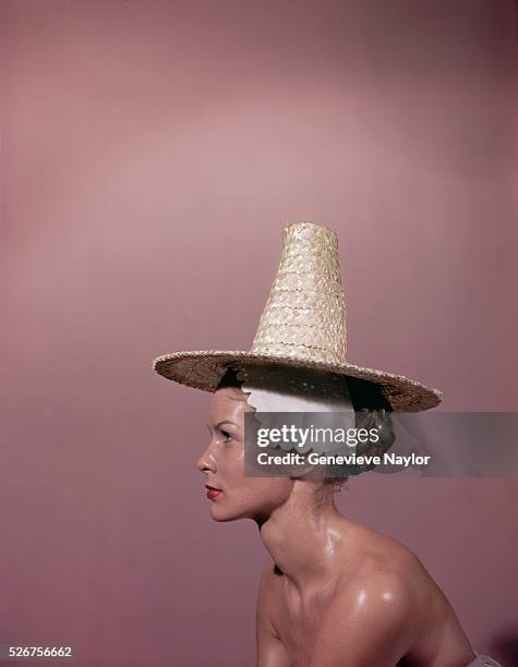 Woman models a straw sun hat.