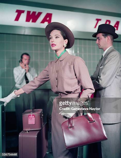 Marilyn Ambrose models a tan day suit at the TWA terminal in La Guardia Airport.