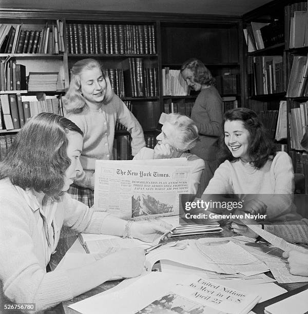 Vassar College undergraduates look over papers in the college library.