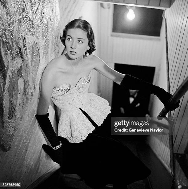 Actress Suzy Parker models a white cotton on black velvet evening gown by Anna Miller.