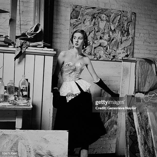 Actress Suzy Parker models a white cotton on black velvet evening gown by Anna Miller.