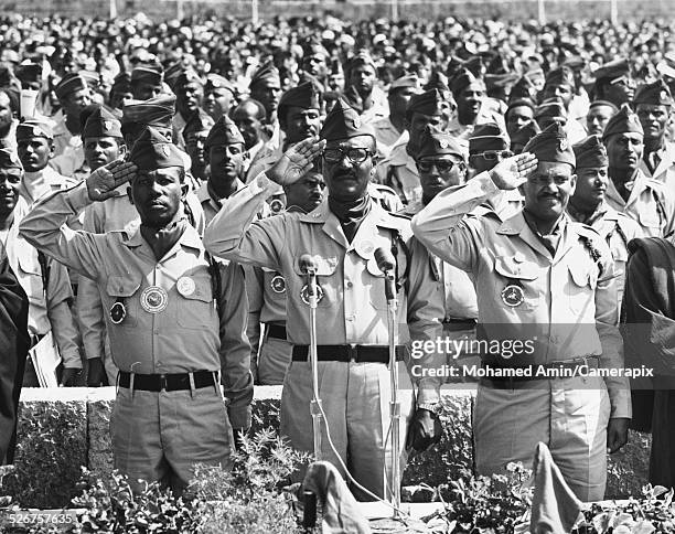 Ethiopian politicians: Major Mengistu Haile Mariam, Brig Gen Tafari Banti and Lt Col Atnafu Abate, in front of a large group of Ethiopian Military...