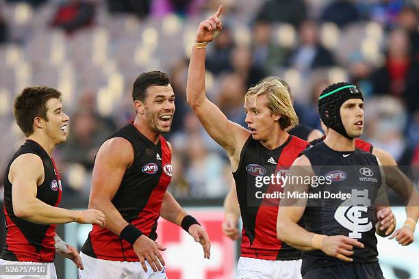 Darcy Parish of the Bombers celebrates a goal with Zach Merrett and Ryan Crowley during the round six AFL match between the Carlton Blues and the...