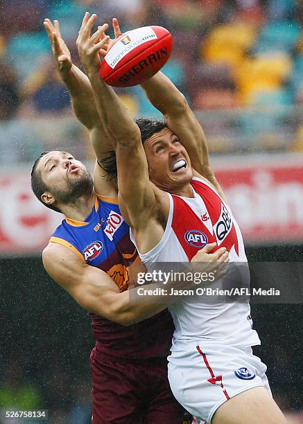 Kurt Tippett of the Swans contests a mark with Stefan Martin of the Lions during the round six AFL match between the Brisbane Lions and the Sydney...