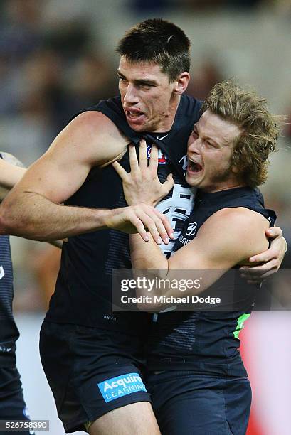 Liam Sumner of the Blues celebrates a goal with Matthew Kreuzer during the round six AFL match between the Carlton Blues and the Essendon Bombers at...
