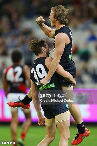 Liam Sumner of the Blues celebrates a goal with Dale Thomas during the round six AFL match between the Carlton Blues and the Essendon Bombers at...