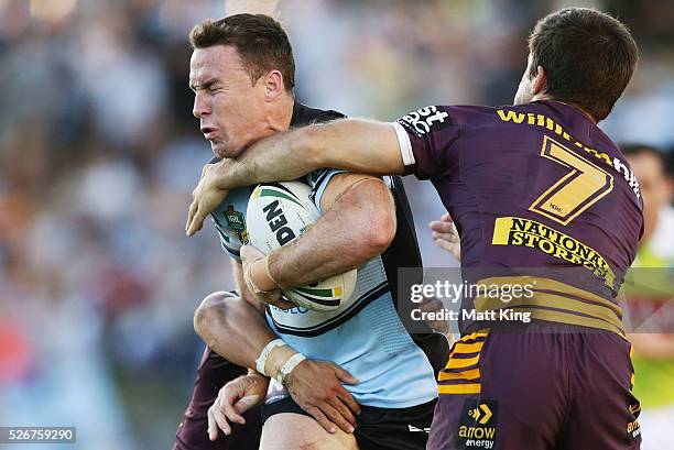 James Maloney of the Sharks is tackled by Ben Hunt of the Broncos during the round nine NRL match between the Cronulla Sharks and the Brisbane...