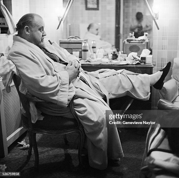 Burl Ives sits before a dressing table in full makeup for his part as "Big Daddy" in the Broadway production of Tennesee Williams' play, Cat on a Hot...