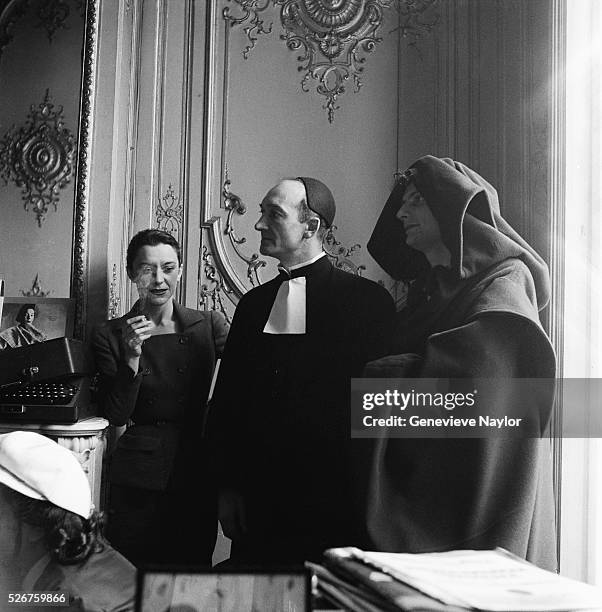 Maria Casares stands by two actors wearing costumes designed by Elsa Schiaparelli for a production at the Comedie Francaise.