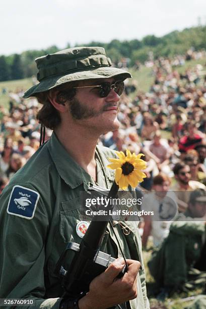 Vietnam veteran with a flower in his gun attends an anti-Vietnam War rally at Valley Forge, Pennsylvania.