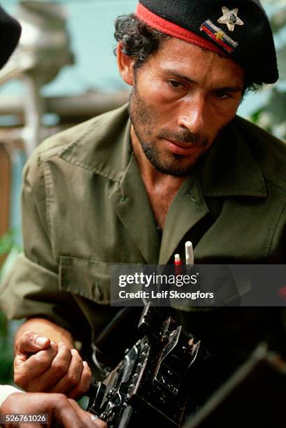 Panamanian advisor to the Sandinista rebels in Nicaragua works on a 50 caliber machine gun.