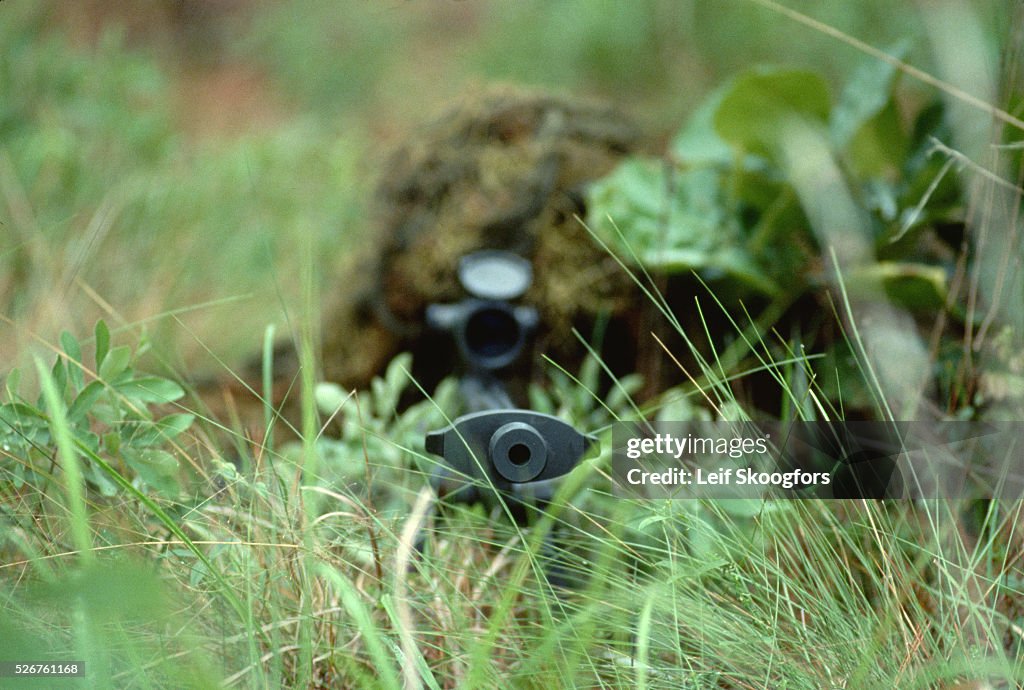Rifle of a Camouflaged Sniper