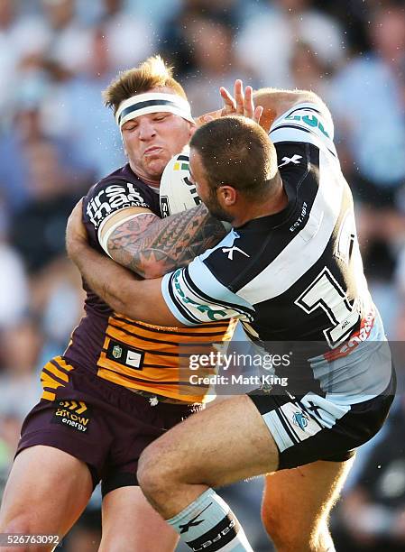 Corey Parker of the Broncos is tackled by Wade Graham of the Sharks during the round nine NRL match between the Cronulla Sharks and the Brisbane...