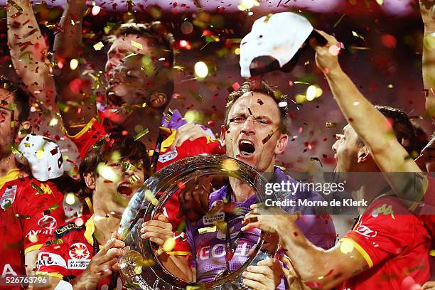 United goalkeeper Eugene Galekovic celebrates with the trophy after the 2015/16 A-League Grand Final match between Adelaide United and the Western...