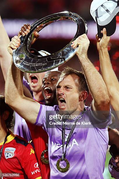 United goalkeeper Eugene Galekovic celebrates with the trophy after the 2015/16 A-League Grand Final match between Adelaide United and the Western...